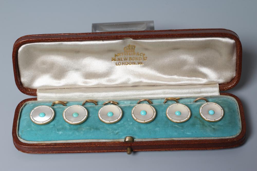 A SET OF SIX SHIRT STUDS, the circular mother-of-pearl panels centred by a turquoise bead within a Image
