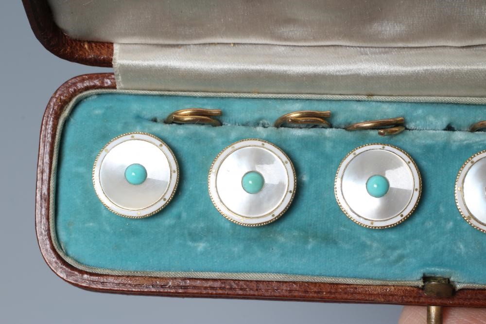 A SET OF SIX SHIRT STUDS, the circular mother-of-pearl panels centred by a turquoise bead within a Image