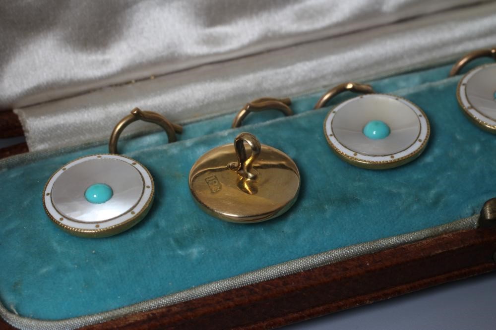 A SET OF SIX SHIRT STUDS, the circular mother-of-pearl panels centred by a turquoise bead within a Image