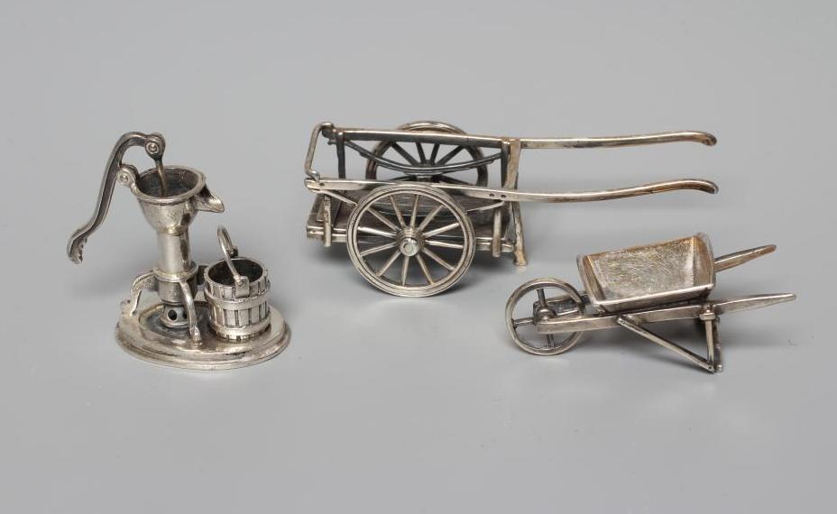 THREE MINIATURE SILVER MODELS all stamped 925, comprising a wheel barrow, 2 1/4" long, pump with Image