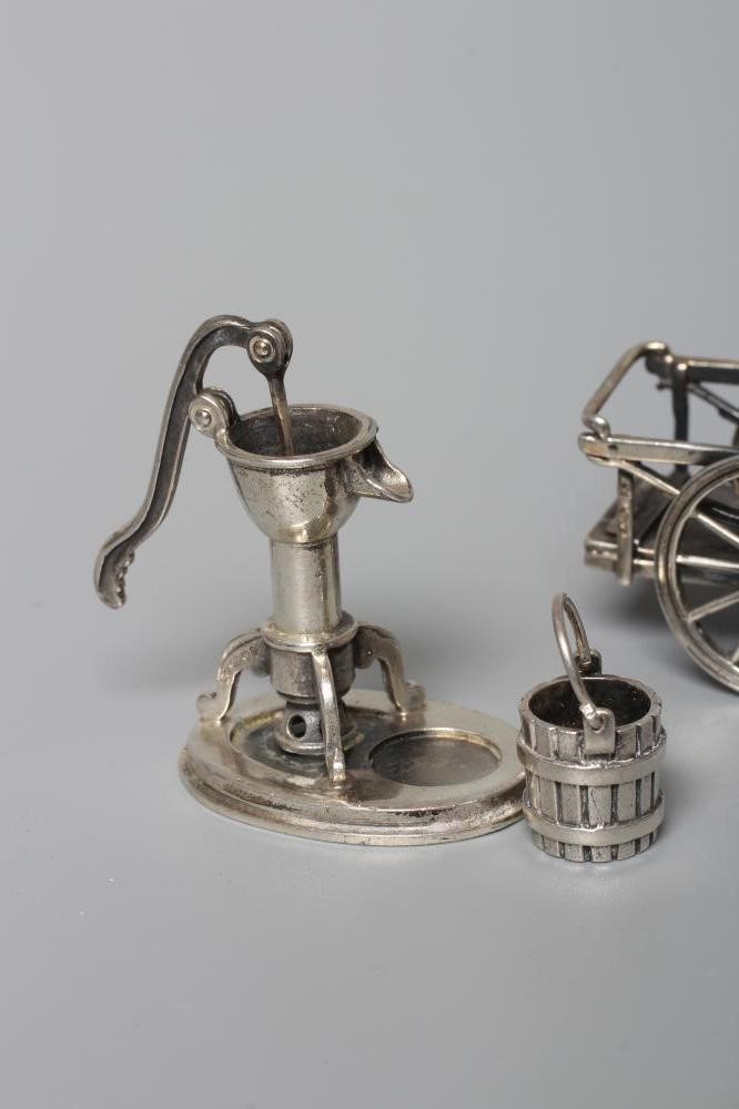 THREE MINIATURE SILVER MODELS all stamped 925, comprising a wheel barrow, 2 1/4" long, pump with Image
