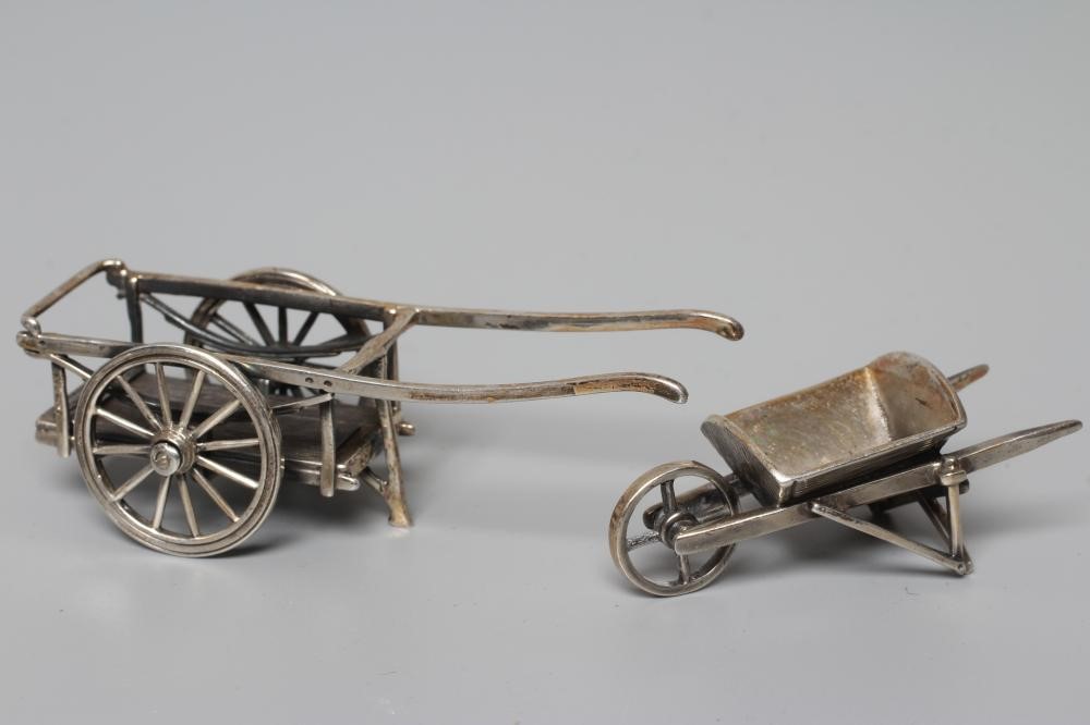 THREE MINIATURE SILVER MODELS all stamped 925, comprising a wheel barrow, 2 1/4" long, pump with Image