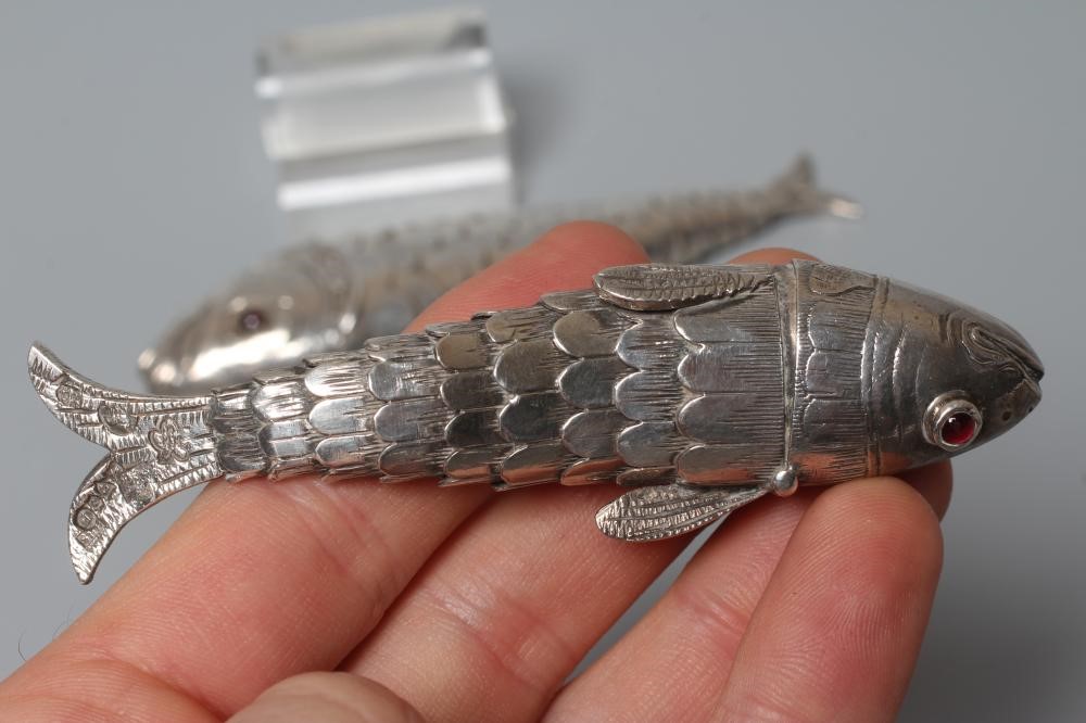 TWO SMALL SILVER ARTICULATED FISH BOXES, one Chester import 1903, with inset red glass eyes, 4" Image
