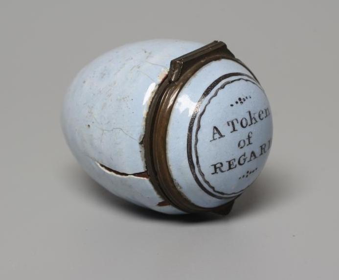A SOUTH STAFFORDSHIRE ENAMEL ON COPPER EGG, late 18th century, the hinged cover inscribed 'A Token Image