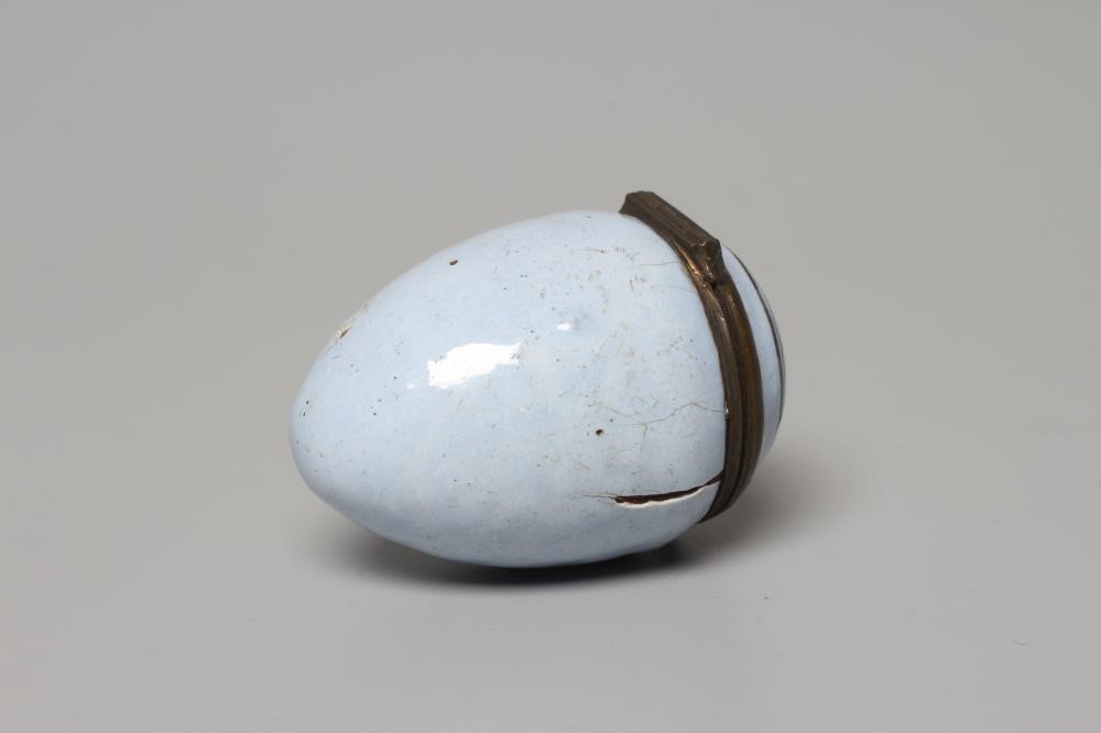 A SOUTH STAFFORDSHIRE ENAMEL ON COPPER EGG, late 18th century, the hinged cover inscribed 'A Token Image