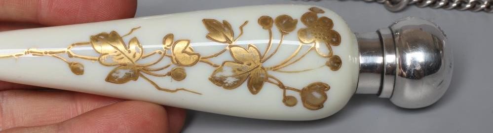 A THOMAS WEBB CREAM OPALINE GLASS SCENT FLASK of conical form with gilded flowers in the style of Image