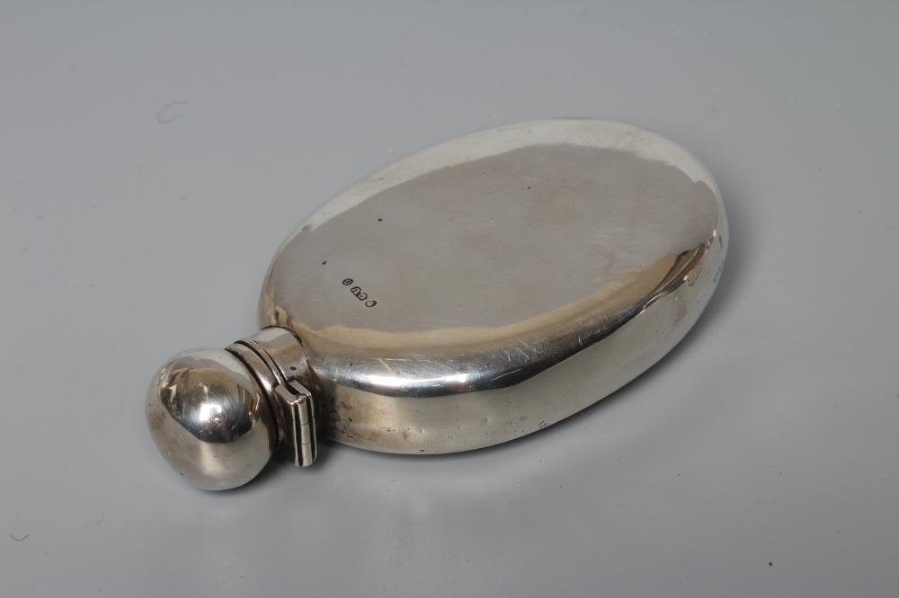 A VICTORIAN SILVER HIP FLASK by George Unite, London 1869, of flattened oval section with hinged Image