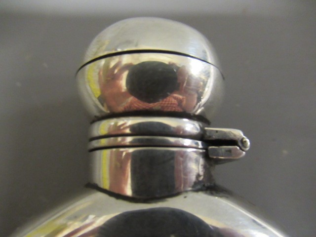 A VICTORIAN SILVER HIP FLASK by George Unite, London 1869, of flattened oval section with hinged Image