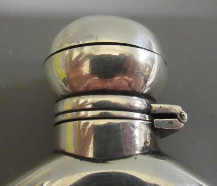 A VICTORIAN SILVER HIP FLASK by George Unite, London 1869, of flattened oval section with hinged Image