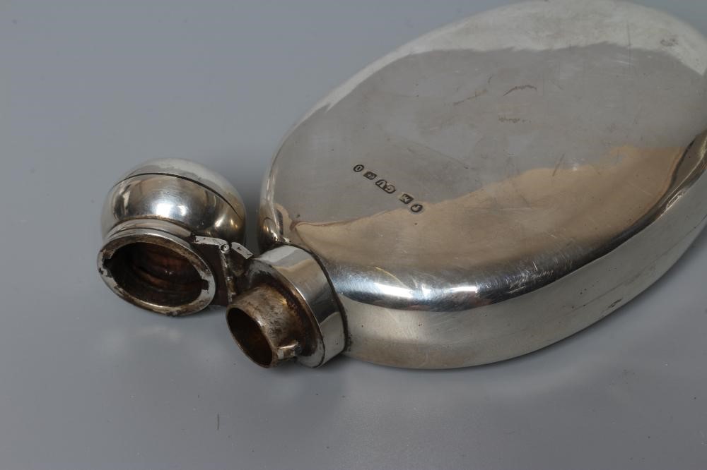 A VICTORIAN SILVER HIP FLASK by George Unite, London 1869, of flattened oval section with hinged Image