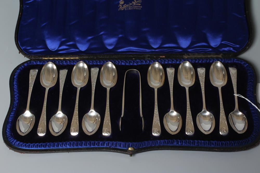 A SET OF TWELVE EDWARDIAN SILVER OLD ENGLISH PATTERN TEASPOONS WITH MATCHING SUGAR TONGS by Josiah Image