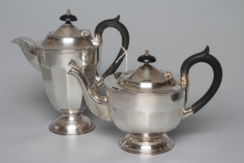 A GEORGE V SILVER TEAPOT AND HOT WATER JUG by Viners, Sheffield 1930, of panelled rounded form on a Image
