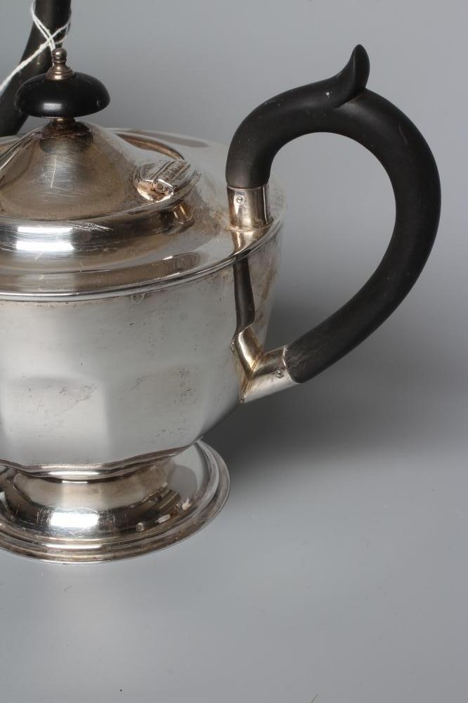 A GEORGE V SILVER TEAPOT AND HOT WATER JUG by Viners, Sheffield 1930, of panelled rounded form on a Image