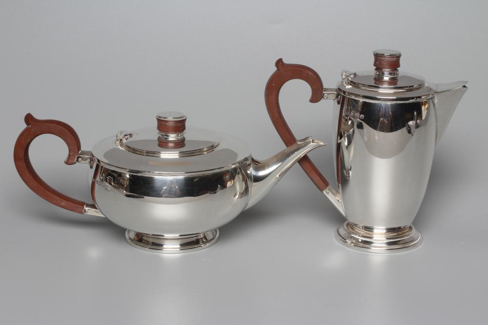 AN ART DECO SILVER TEAPOT AND MATCHING HOT WATER JUG by Hukin & Heath Ltd. Image