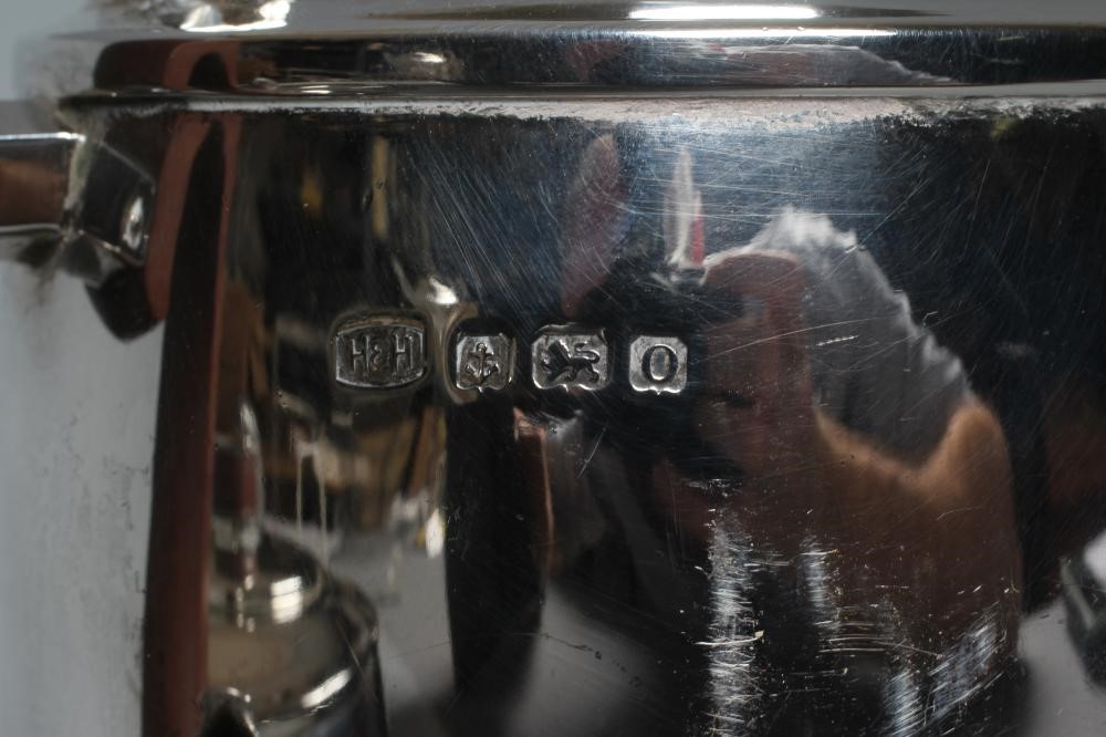 AN ART DECO SILVER TEAPOT AND MATCHING HOT WATER JUG by Hukin & Heath Ltd. Image