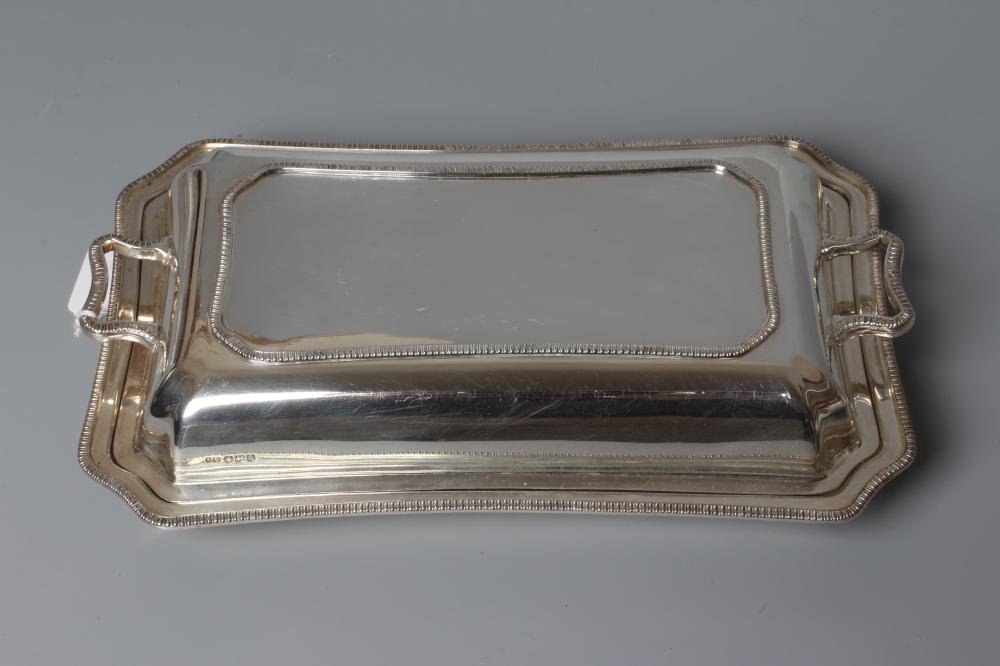 A GEORGE VI SILVER ENTRÉE DISH AND TWO HANDLED COVER by Frank Cobb & Co Ltd. Image