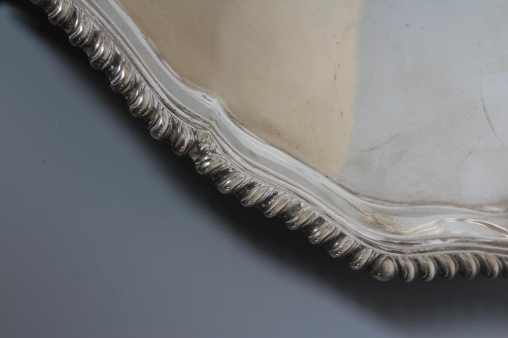A GEORGE V SILVER SALVER by R F Mosley & Co., Sheffield 1929, of shaped circular form with gadrooned Image