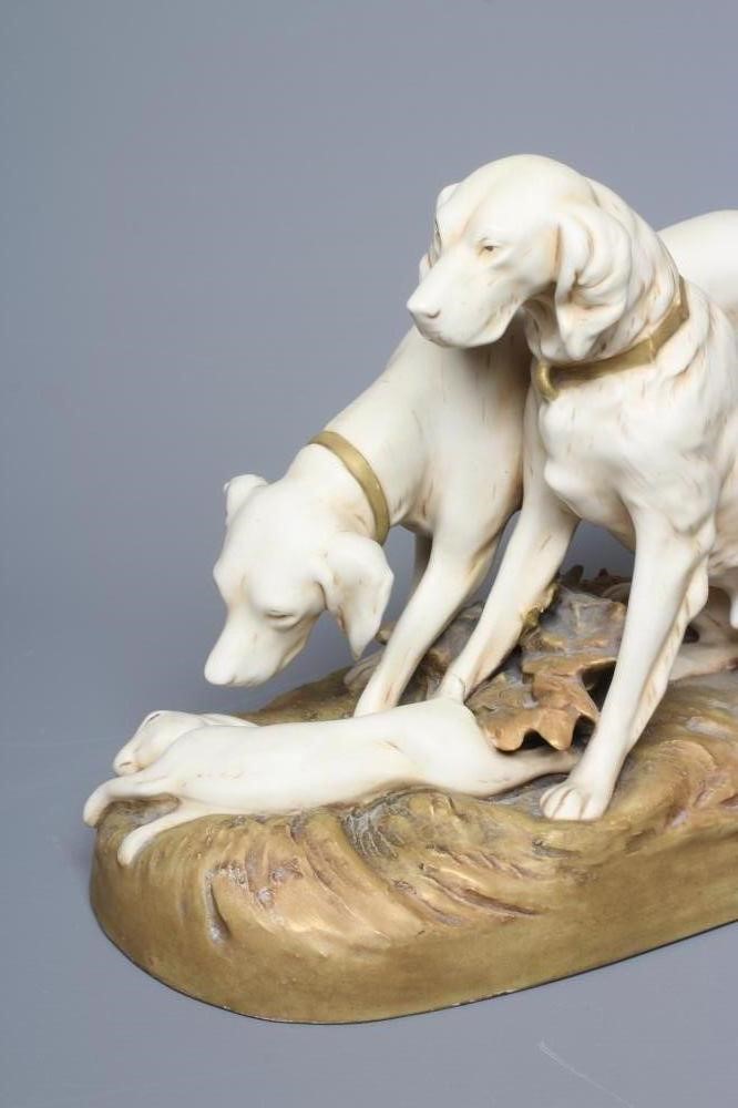 A ROYAL DUX MODEL OF TWO RETRIEVERS, early 20th century, with a dead hare on a naturalistically Image