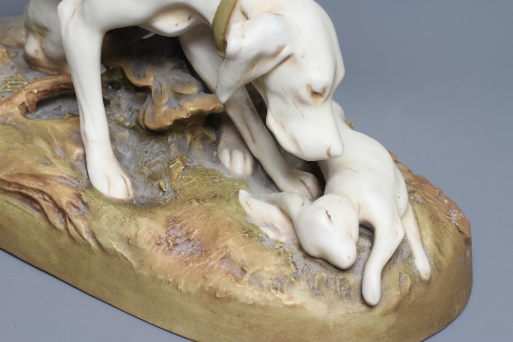 A ROYAL DUX MODEL OF TWO RETRIEVERS, early 20th century, with a dead hare on a naturalistically Image