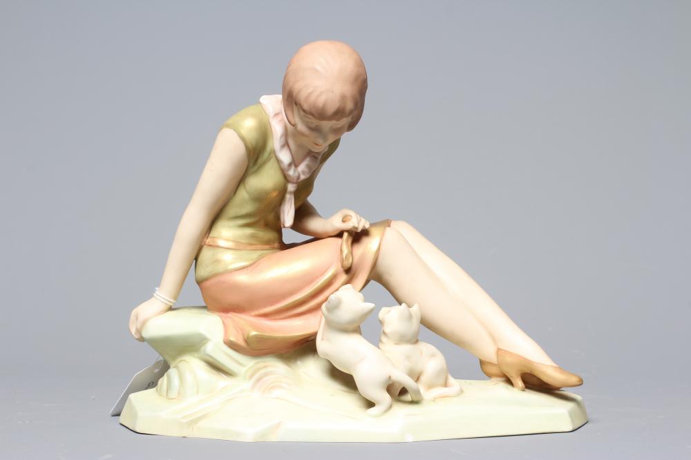 AN ART DECO ROYAL DUX FIGURE modelled as a seated young girl playing with two kittens at her side on Image