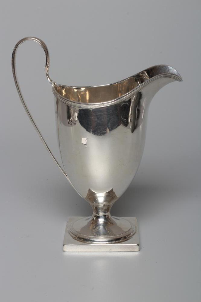 A LATE GEORGE III SILVER HELMET JUG by Robert Hennell, London 1794, with high loop handle on square Image