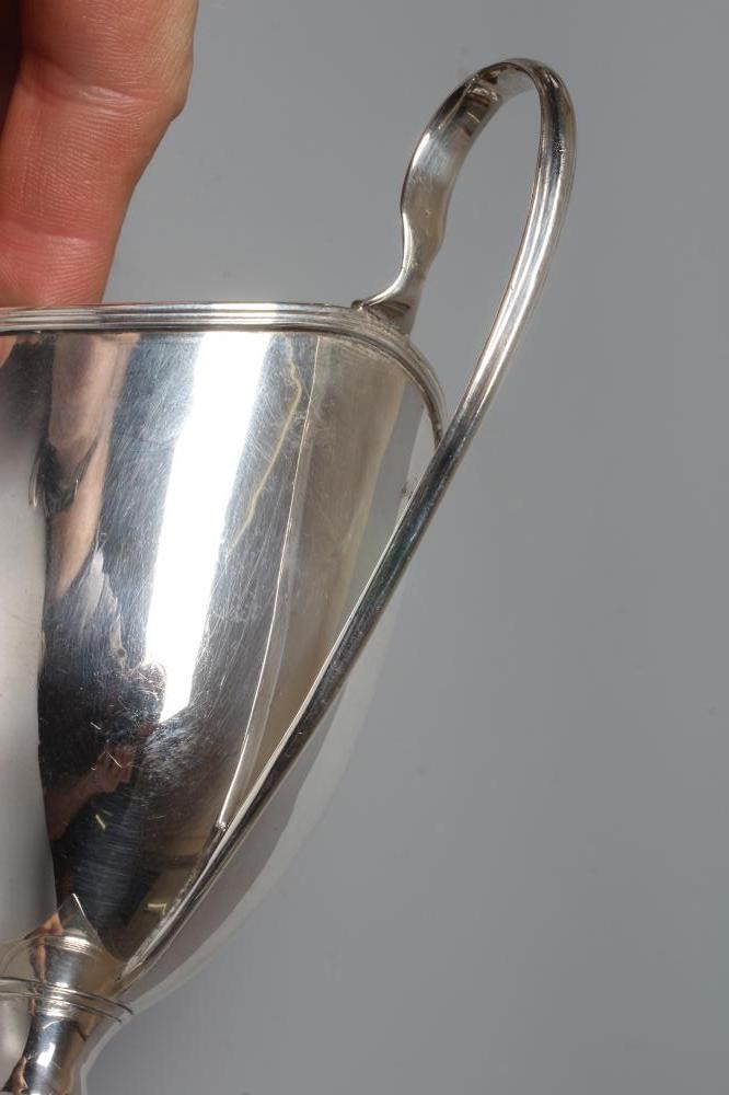 A LATE GEORGE III SILVER HELMET JUG by Robert Hennell, London 1794, with high loop handle on square Image