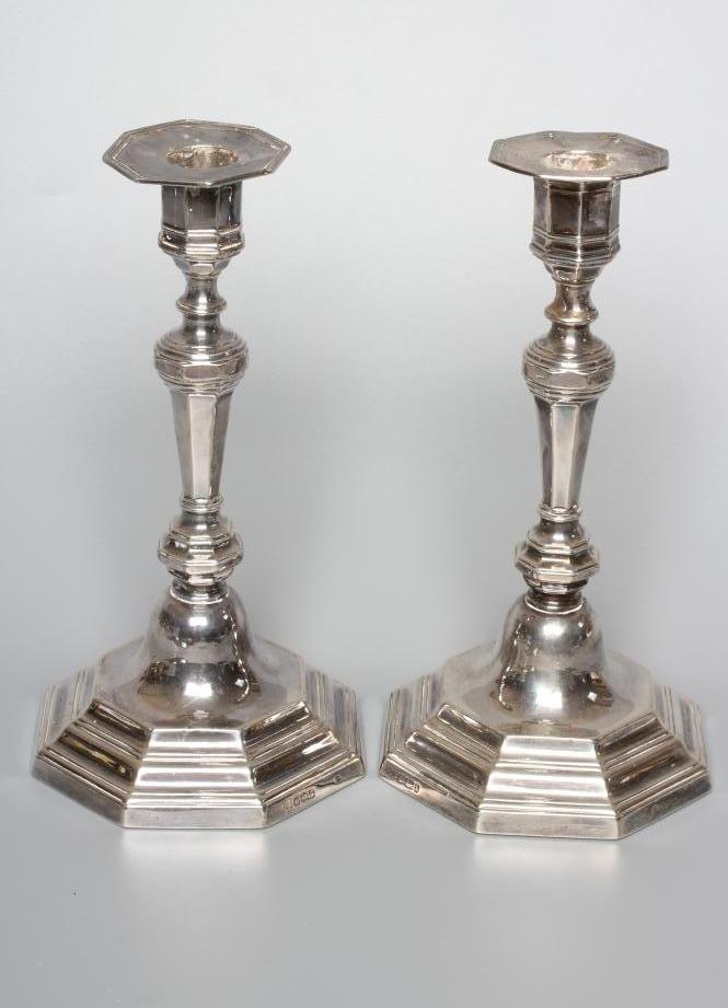 A COMPOSITE PAIR OF EDWARDIAN SILVER CANDLESTICKS by Hawksworth Image