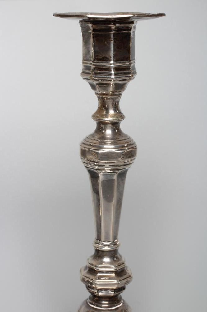 A COMPOSITE PAIR OF EDWARDIAN SILVER CANDLESTICKS by Hawksworth Image