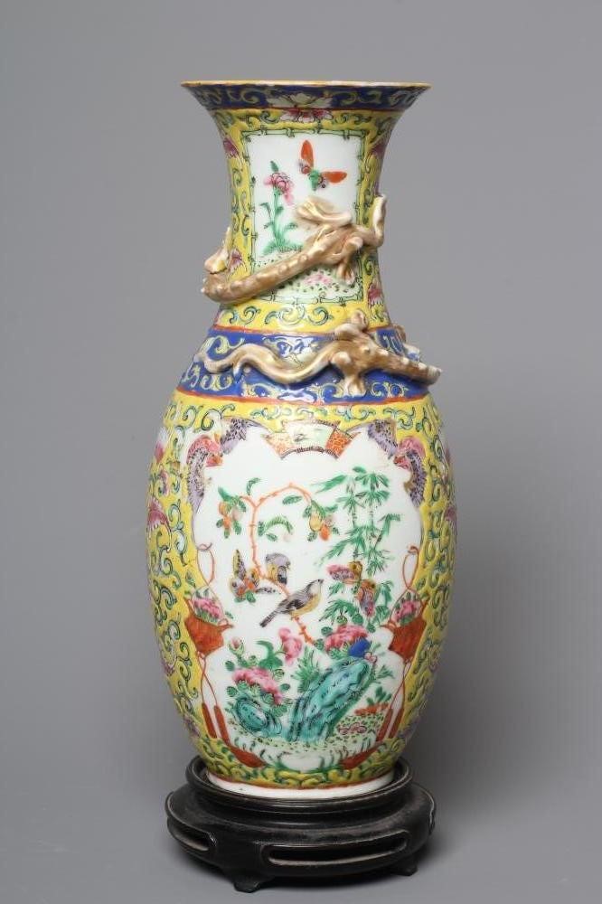 A CHINESE PORCELAIN FAMILLE JEUNE VASE of baluster form with chi-long moulded and applied to the Image