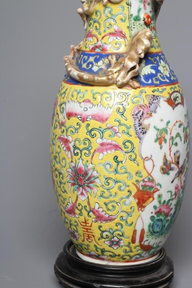 A CHINESE PORCELAIN FAMILLE JEUNE VASE of baluster form with chi-long moulded and applied to the Image