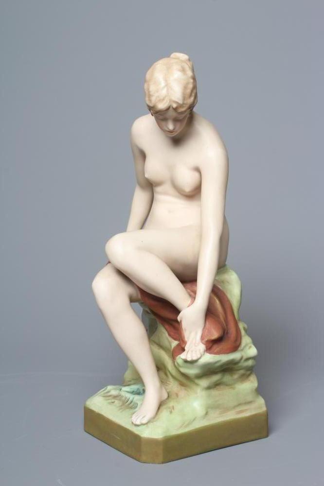 AN ART NOUVEAU ROYAL DUX BATHER, the young female nude seated on a rocky outcrop, model 2942, pink Image