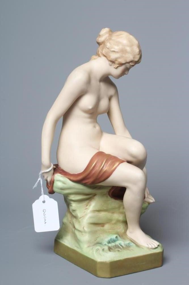 AN ART NOUVEAU ROYAL DUX BATHER, the young female nude seated on a rocky outcrop, model 2942, pink Image