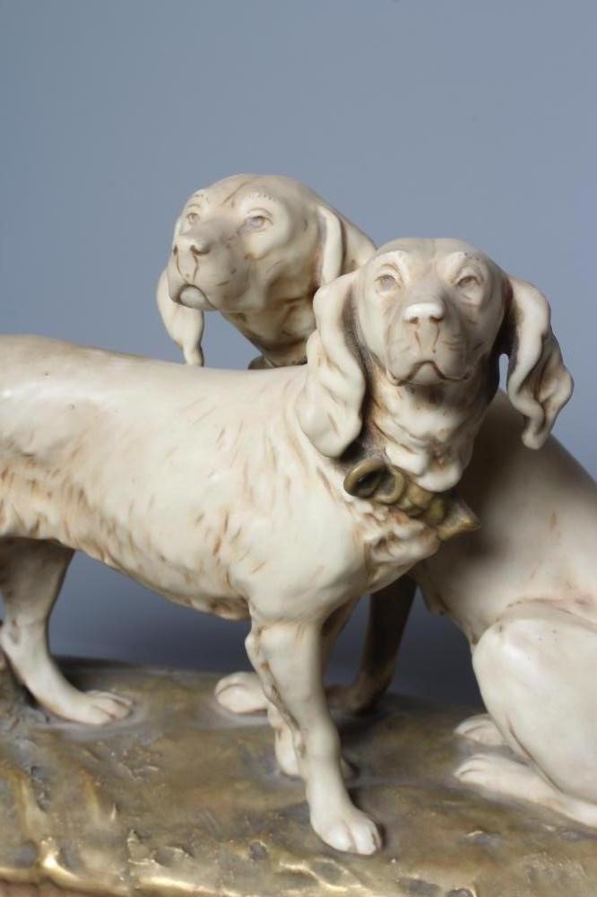 A ROYAL DUX MODEL OF TWO SETTERS, one seated and one standing on a naturalistically moulded oval Image