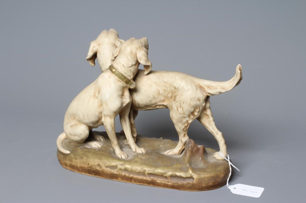 A ROYAL DUX MODEL OF TWO SETTERS, one seated and one standing on a naturalistically moulded oval Image