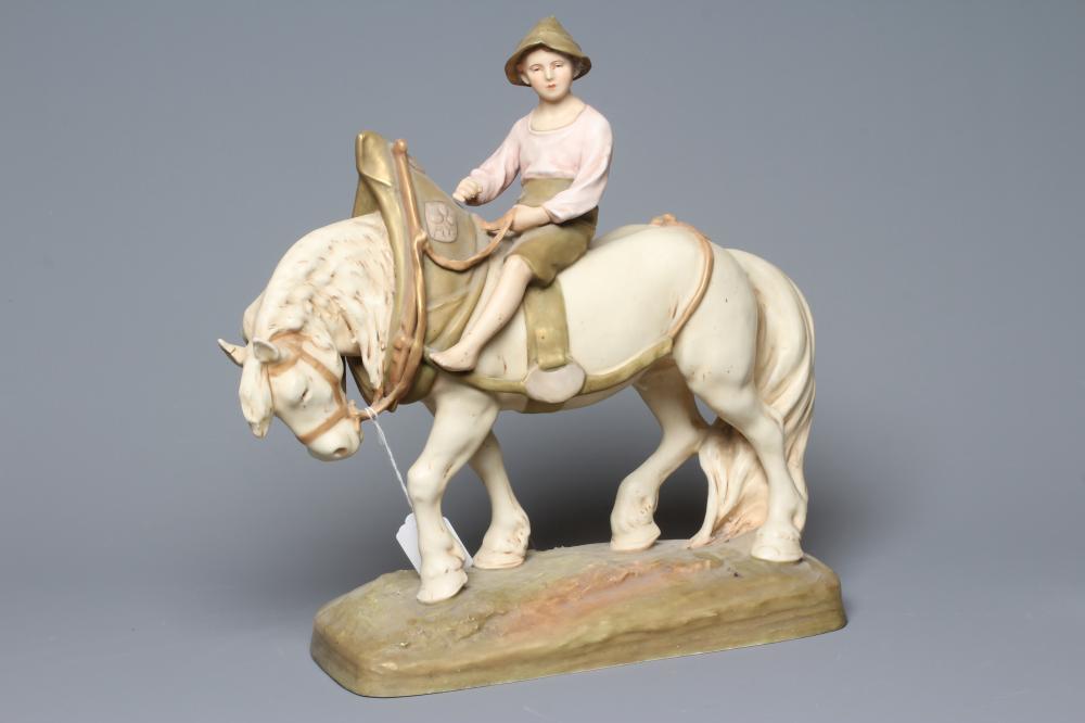 A ROYAL DUX SHIRE HORSE in harness and with a young boy in traditional garb seated astride, on a Image