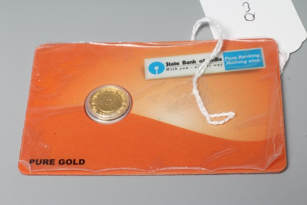 A STATE BANK OF INDIA 'PURE GOLD' PIECE, in sealed credit card, fineness stamped 999.9, 2gms Image