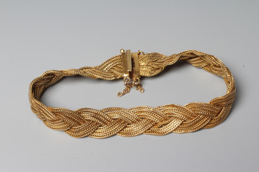 AN ITALIAN BRACELET BY UNOERRE OF AREZZO, stamped 750, the three strand plait with tongue fastener, Image