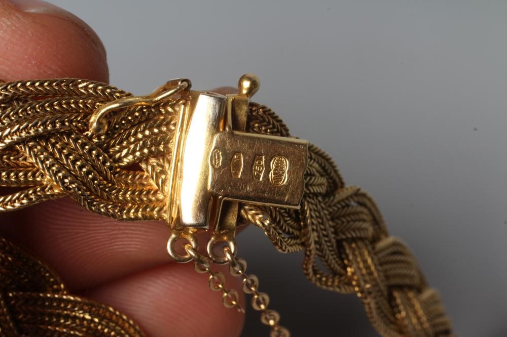 AN ITALIAN BRACELET BY UNOERRE OF AREZZO, stamped 750, the three strand plait with tongue fastener, Image