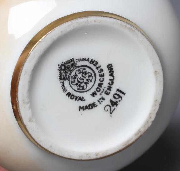 A ROYAL WORCESTER SMALL BOTTLE VASE, 1952, painted by R Smith with a still life vignette of two Image