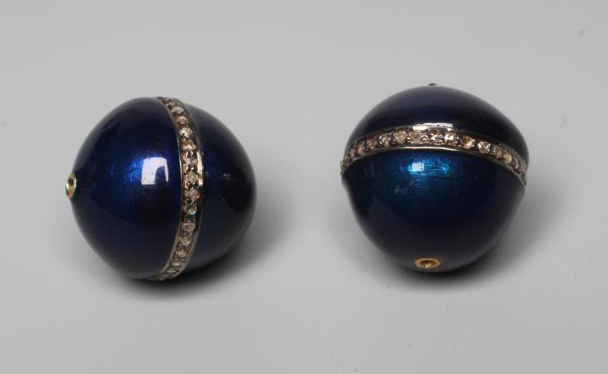 A PAIR OF BLUE ENAMELLED BEADS, each sphere with an inset band of small point set round cut diamonds Image