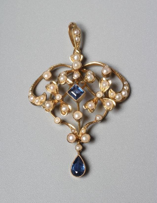 AN EDWARDIAN PENDANT stamped 15, sponsor's mark SS, of open shield form set with seed pearls and two Image