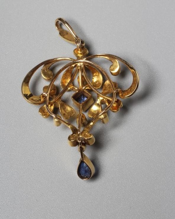 AN EDWARDIAN PENDANT stamped 15, sponsor's mark SS, of open shield form set with seed pearls and two Image