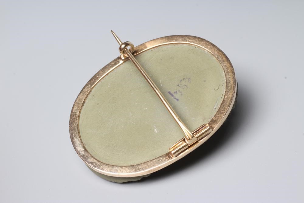 A VICTORIAN OVAL LAVA BROOCH carved in high relief with the head and shoulders portrait of the Greek Image