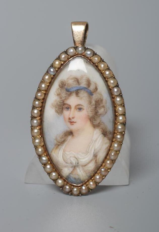 A GEORGIAN PENDANT inset with an eliptical ivory portrait miniature painted with the bust portrait Image
