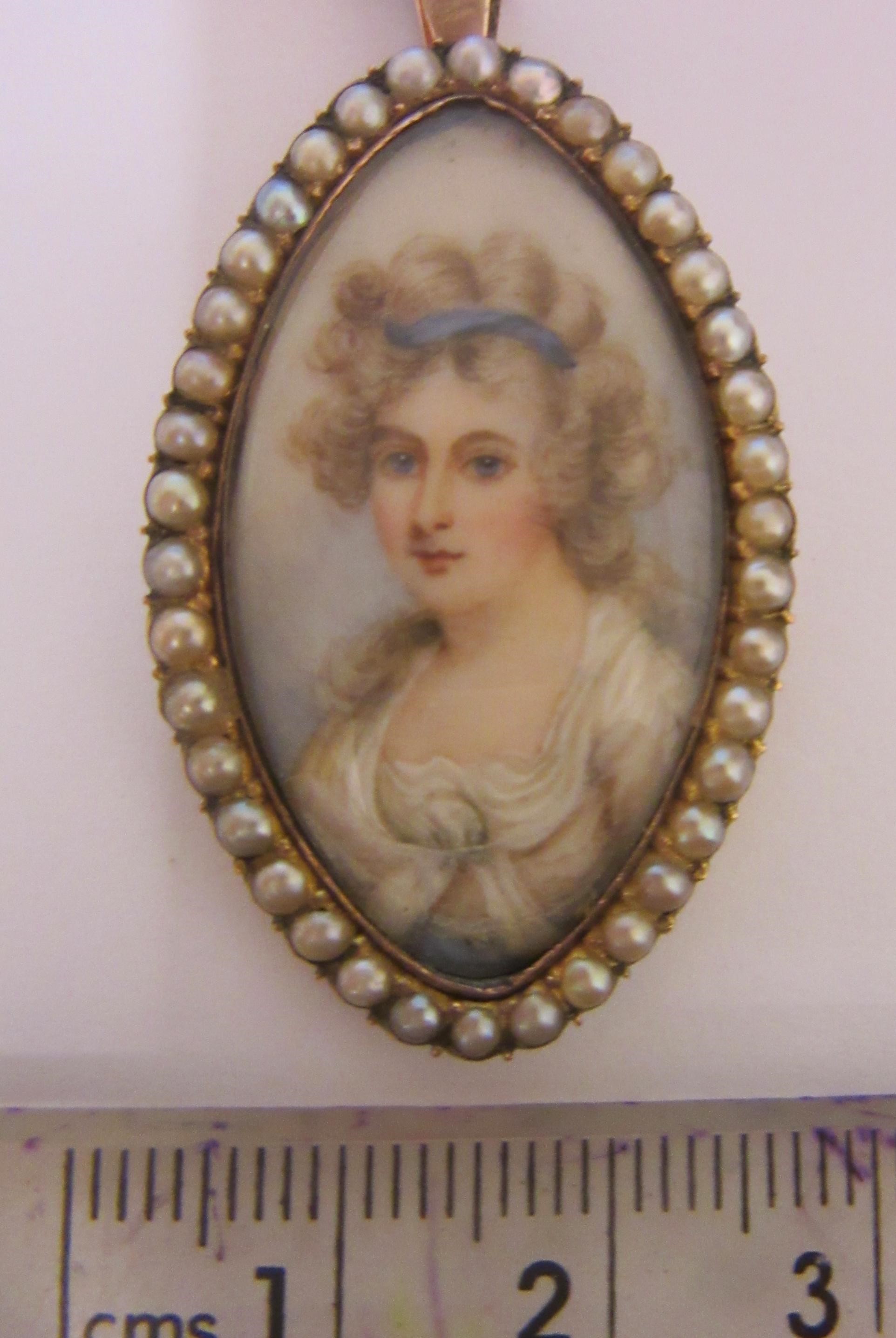 A GEORGIAN PENDANT inset with an eliptical ivory portrait miniature painted with the bust portrait Image