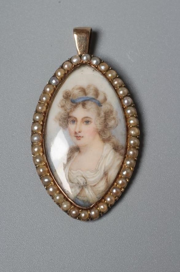 A GEORGIAN PENDANT inset with an eliptical ivory portrait miniature painted with the bust portrait Image
