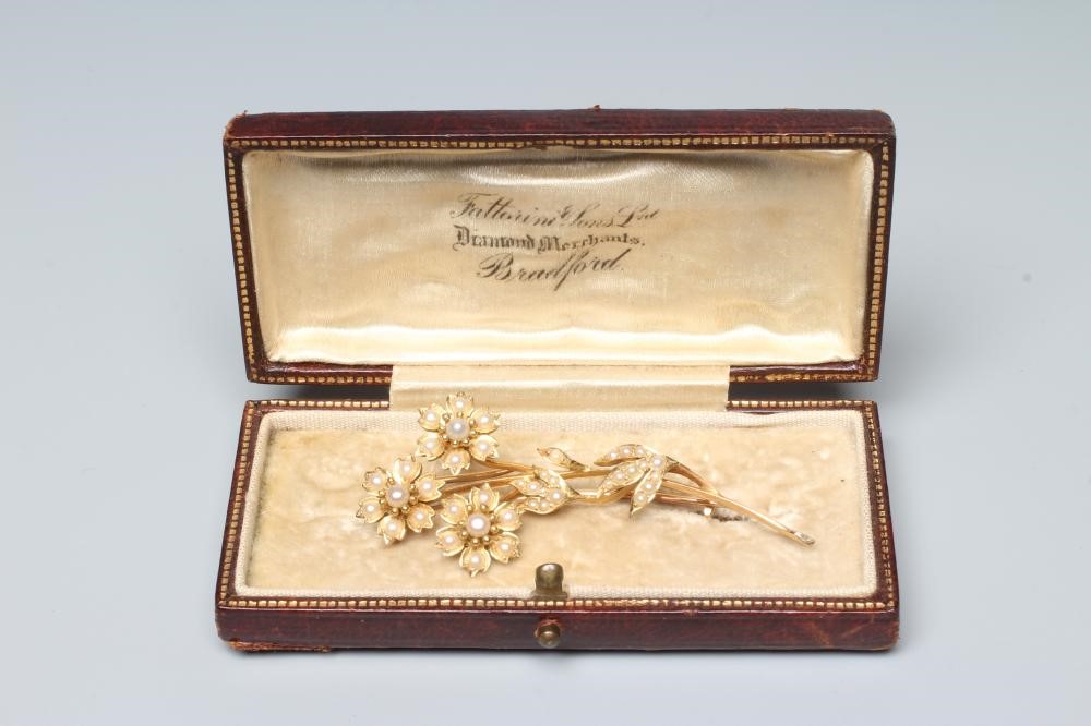 AN EDWARDIAN SEED PEARL SPRAY BROOCH, the three flower heads and leaves inset with numerous seed Image