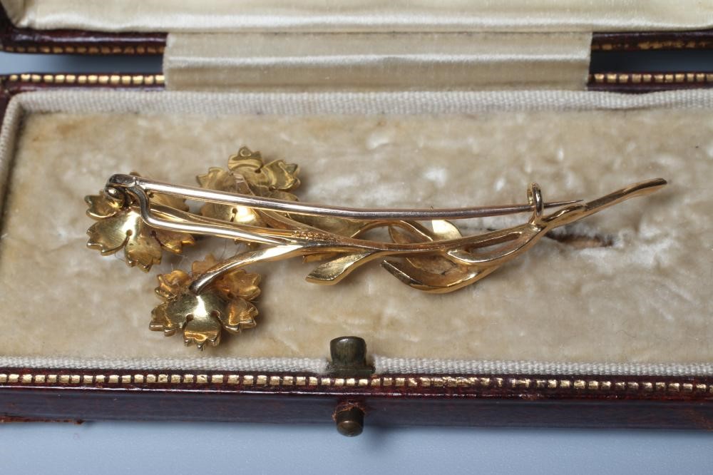 AN EDWARDIAN SEED PEARL SPRAY BROOCH, the three flower heads and leaves inset with numerous seed Image