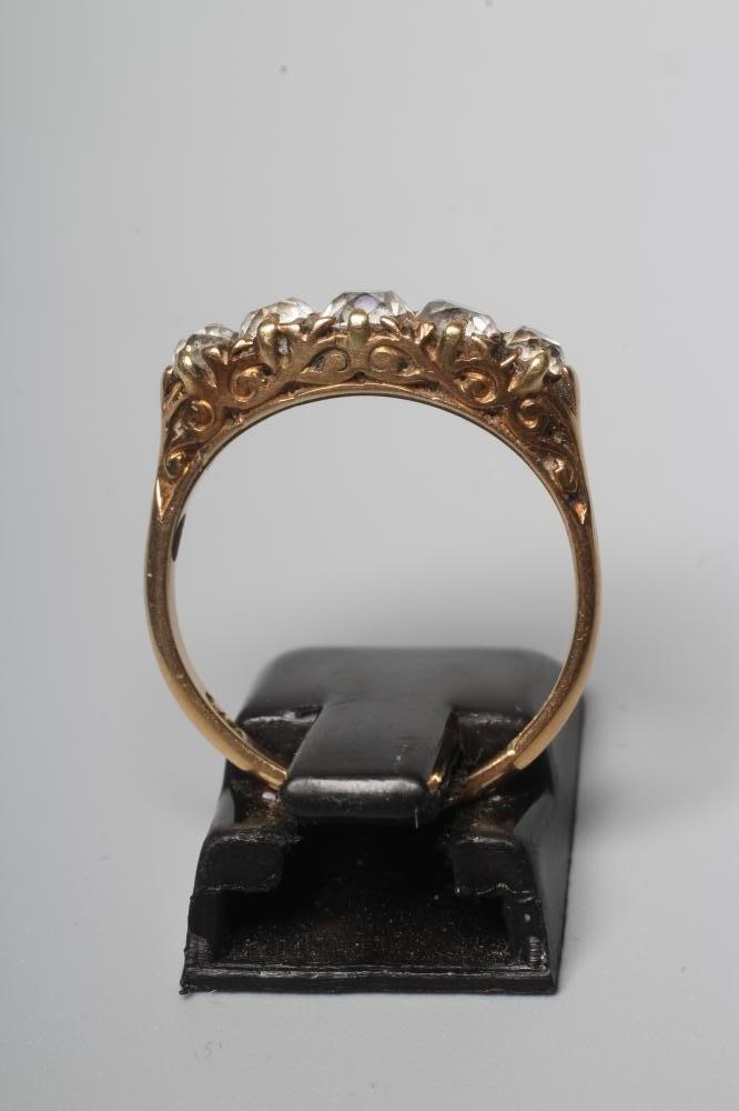 A FIVE STONE DIAMOND RING, the graduated old cut stones set to carved shoulders and a plain shank Image