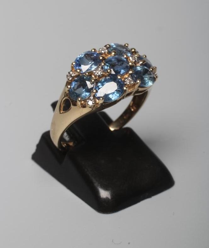 A SAPPHIRE DRESS RING, the seven stones claw set with diamond points between to open shoulders and a Image